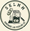 Logo of Homemade Lab Pickling Co. with a jar, magnifying glass, and cucumbers.